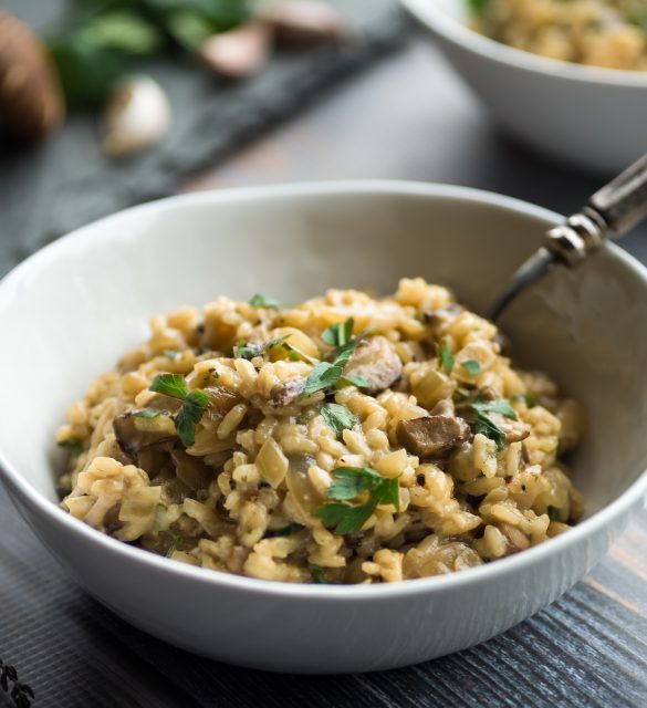 Delicious mushroom risotto with thyme and parsley garnish